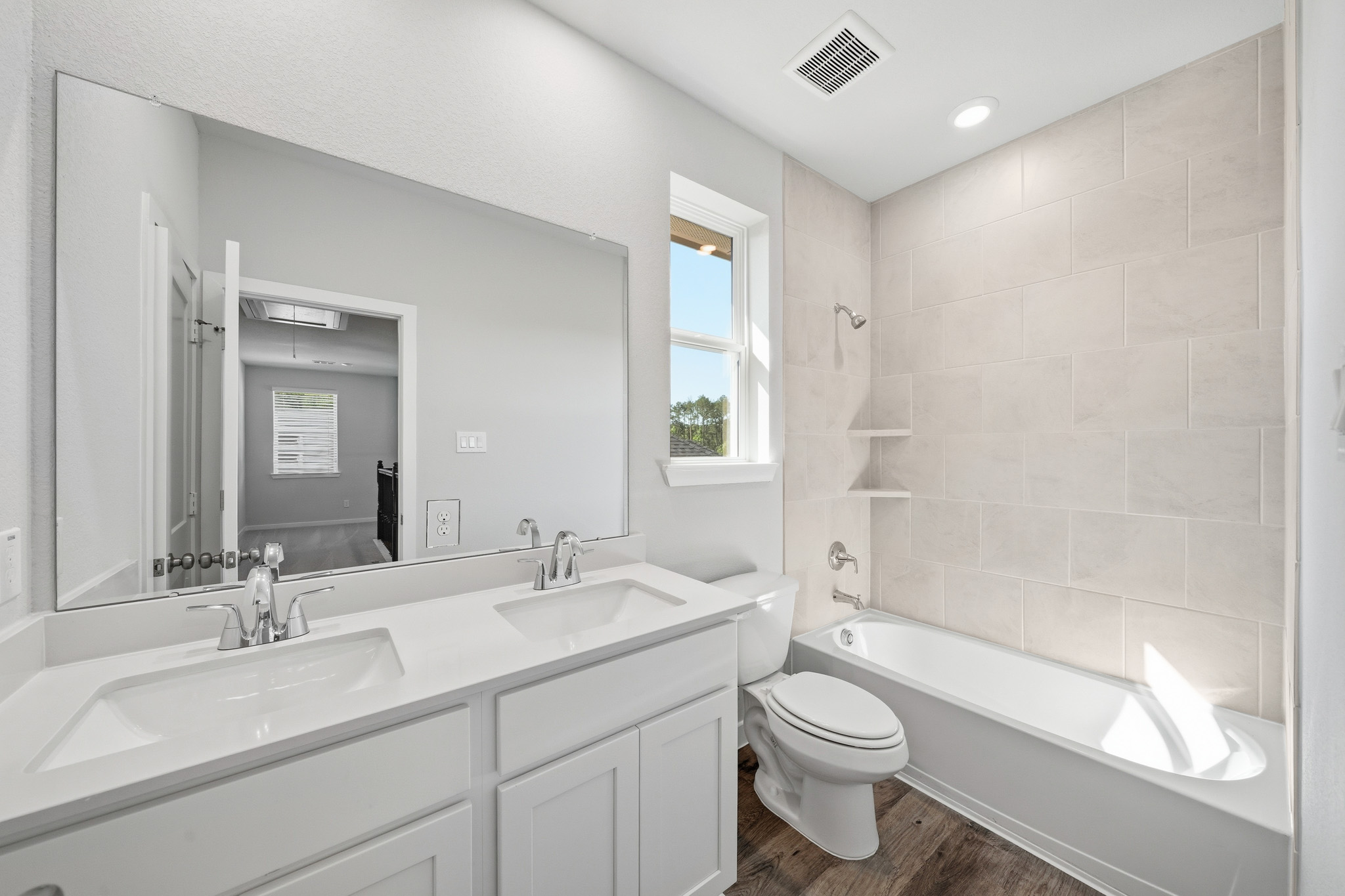 A bathroom with a tub sink and toilet.