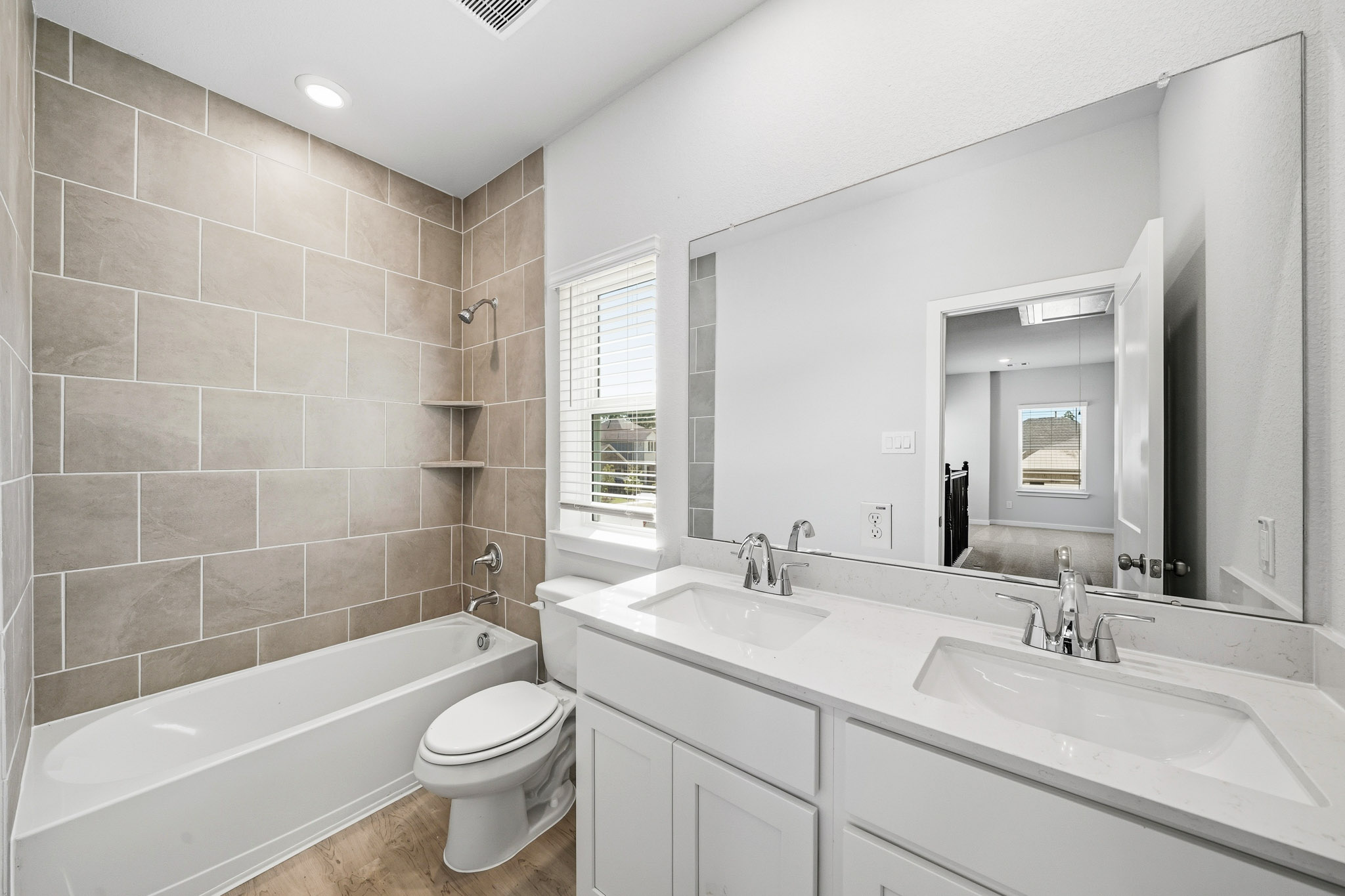 A bathroom with a tub sink and toilet.