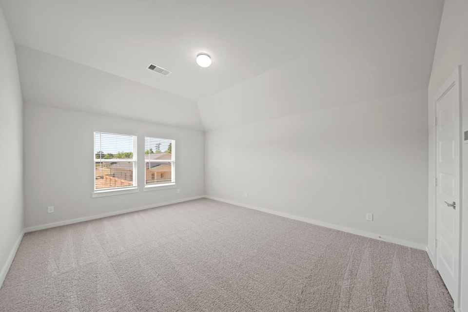 A room with a window and a carpet.