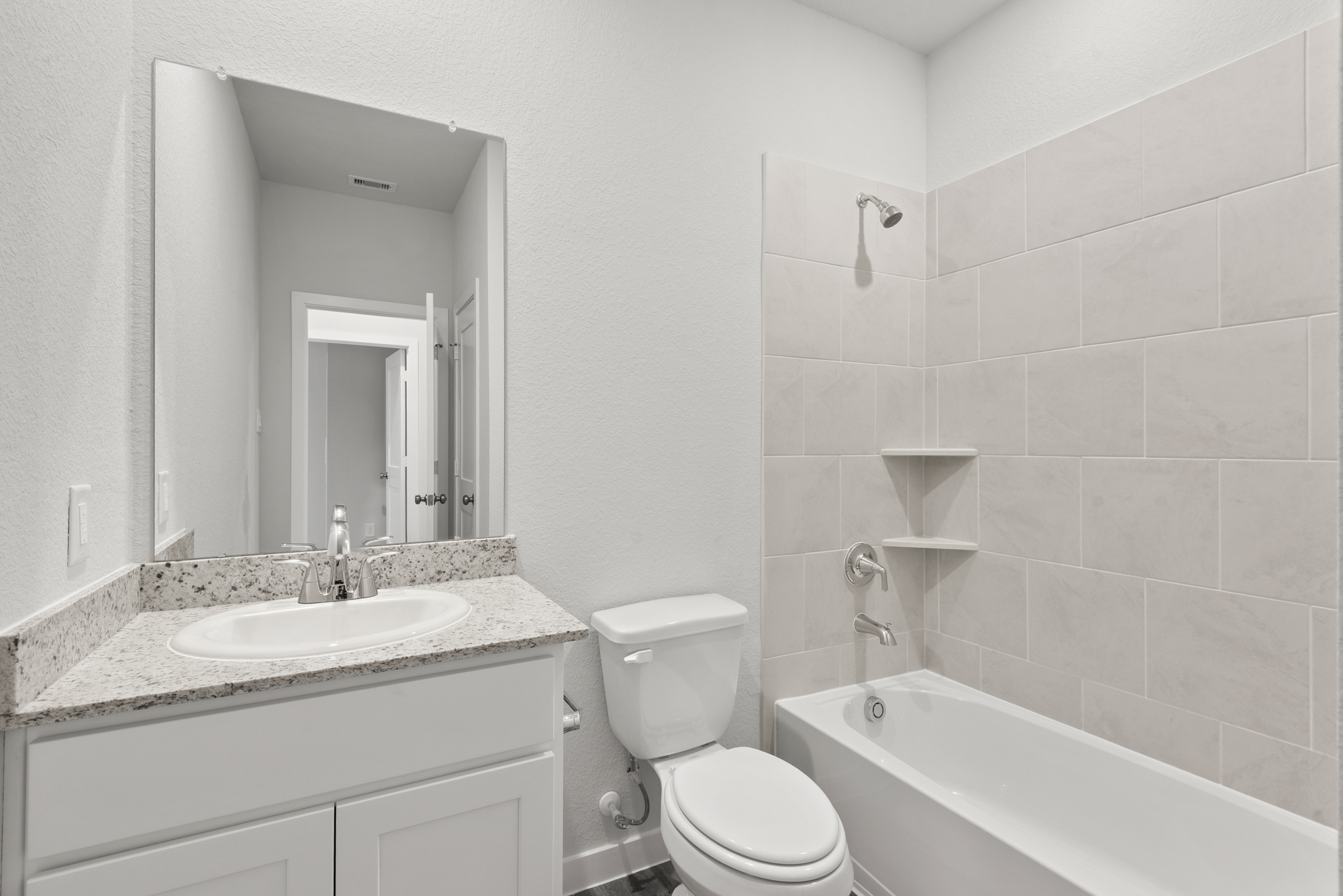 A bathroom with a tub sink and toilet.