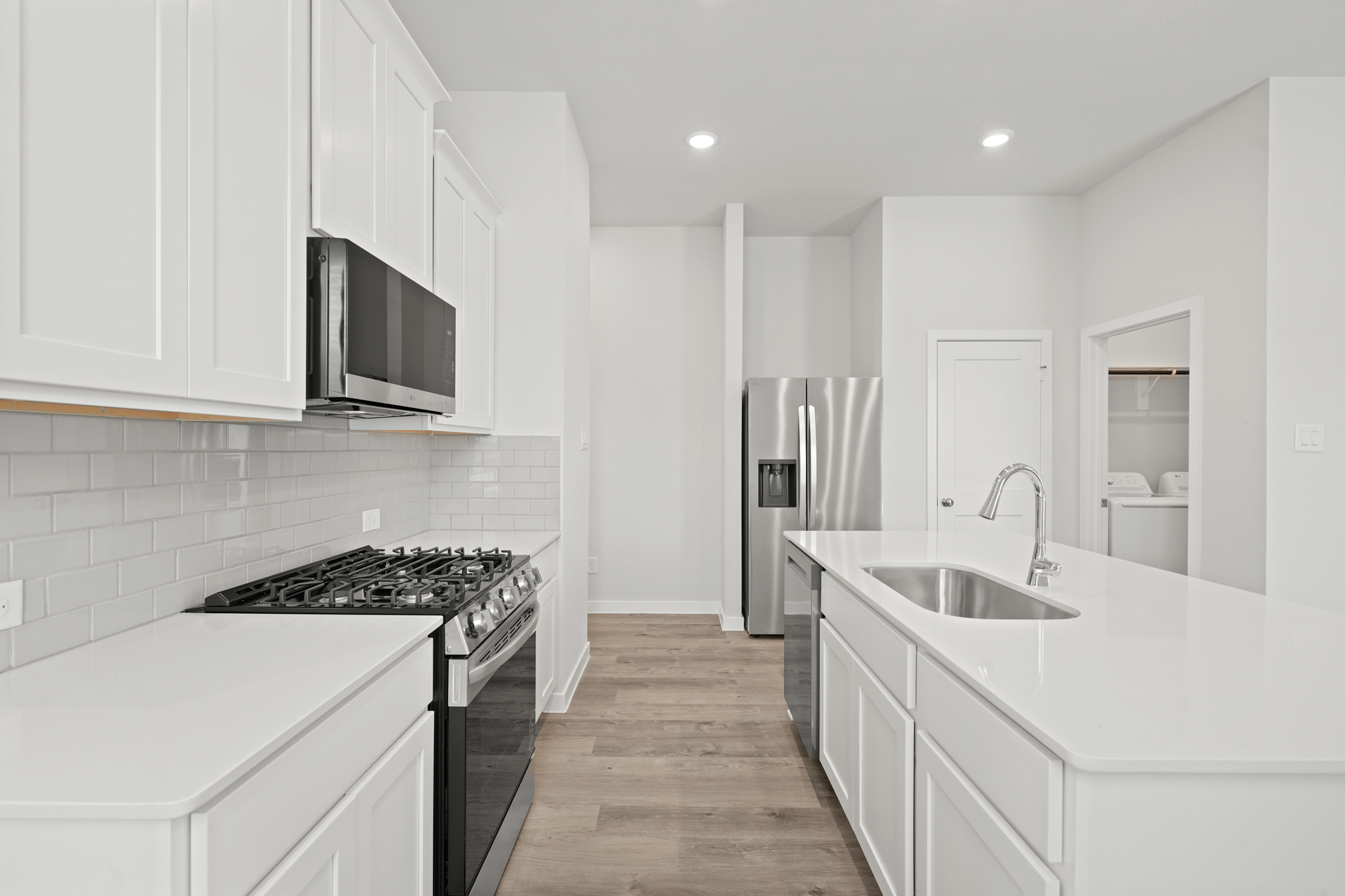A kitchen with white cabinets.