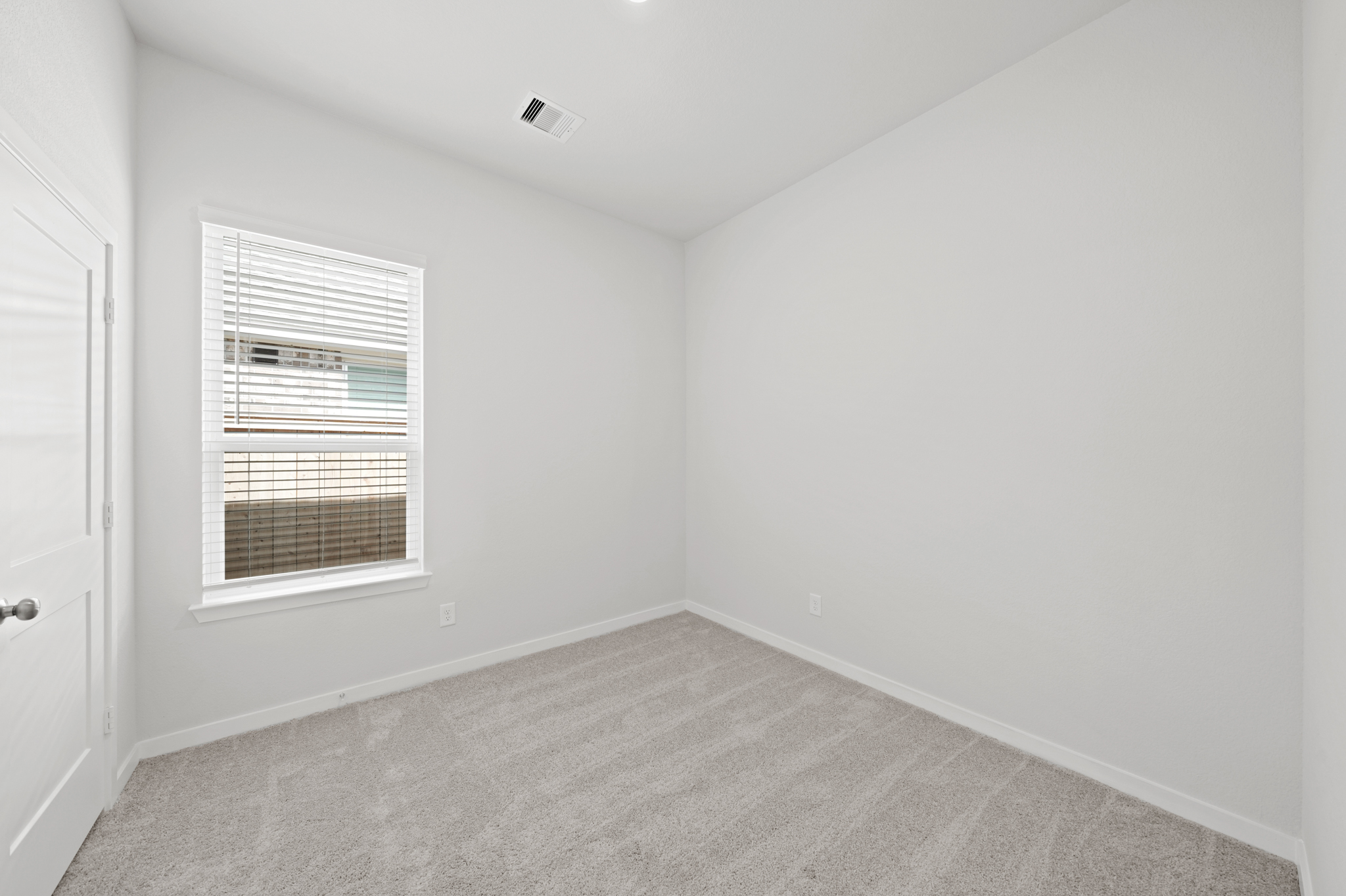 A room with a window and a door.