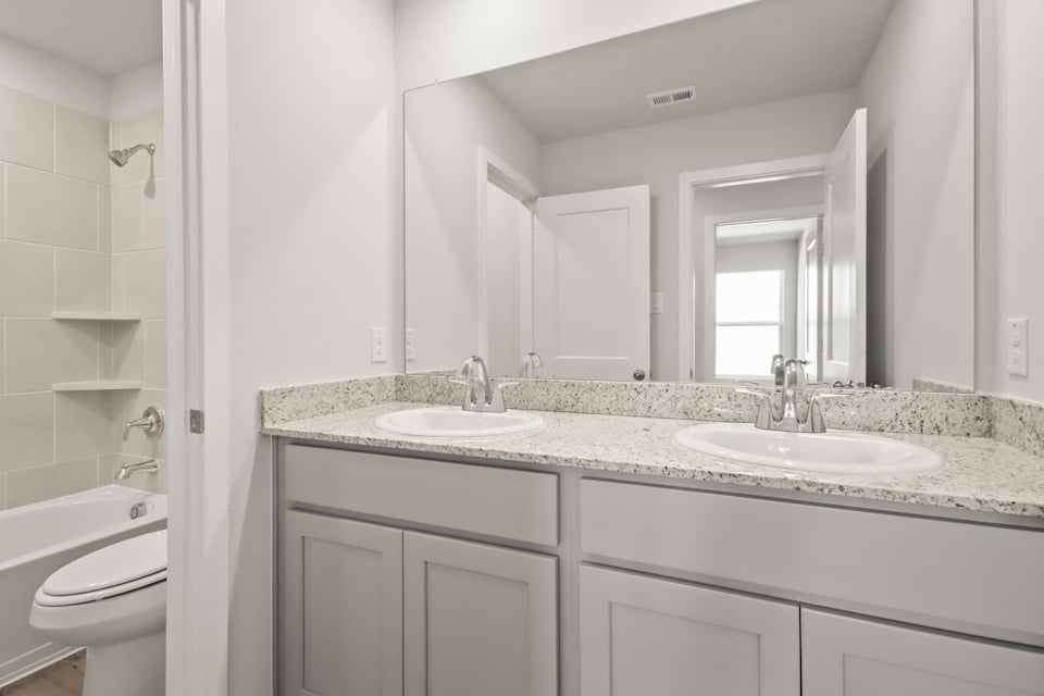 A bathroom with a marble countertop.