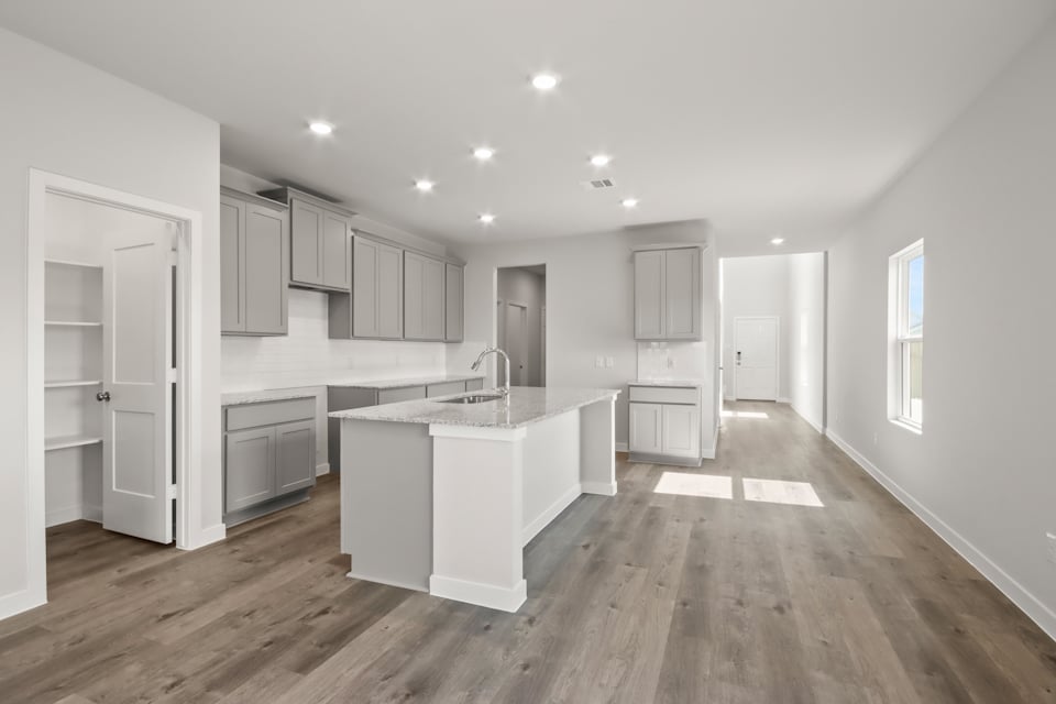A kitchen with white cabinets.