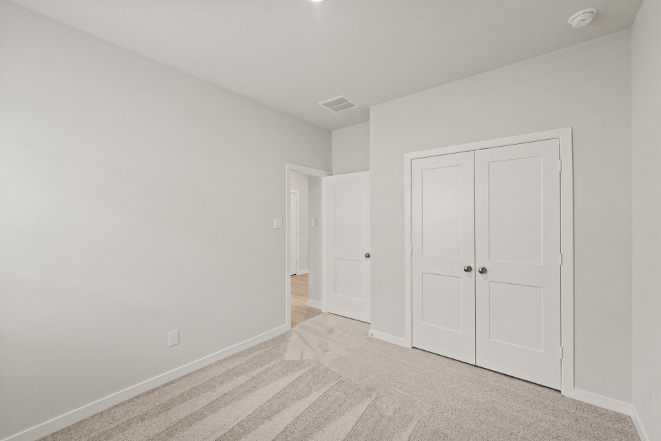 A hallway with white doors.