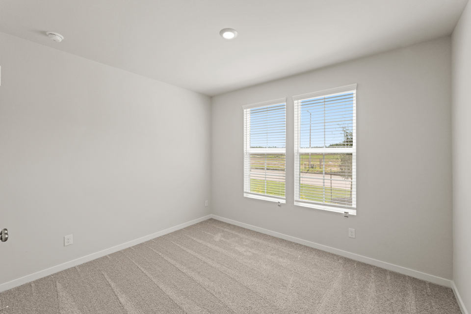 A room with a window and a carpet.