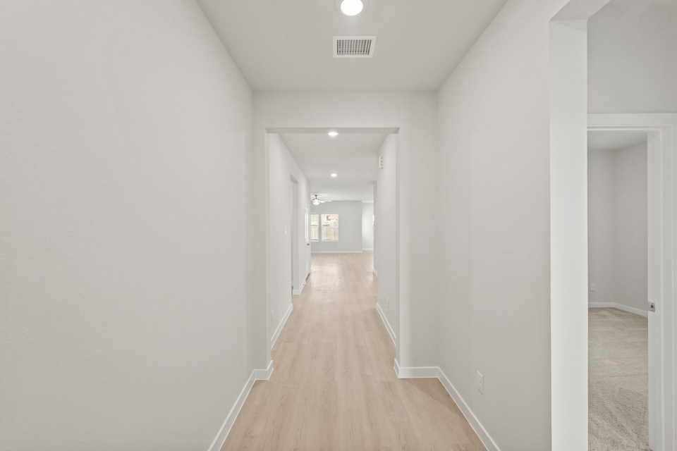 A long hallway with white walls.