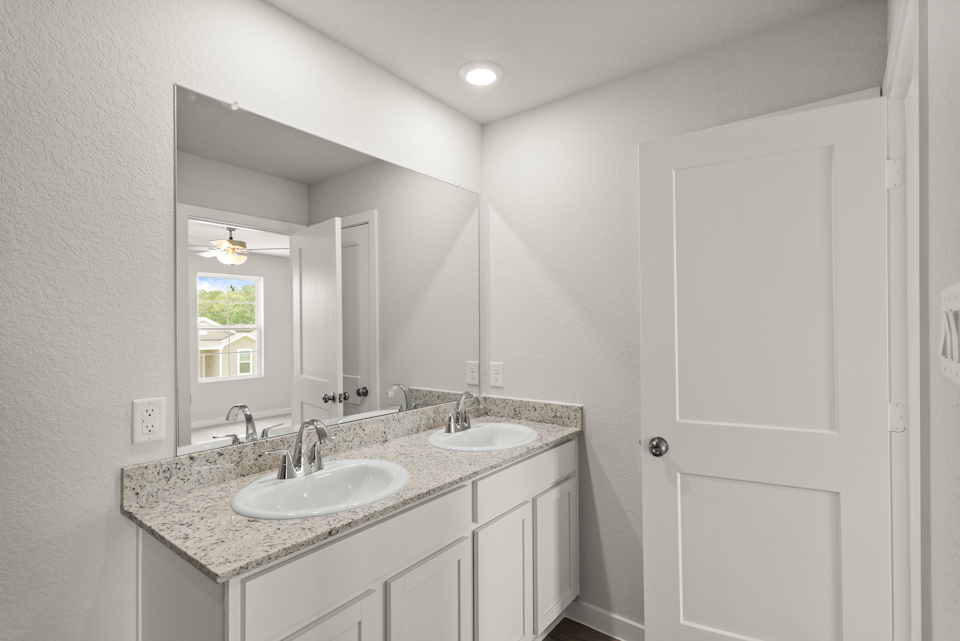 A bathroom with a marble countertop.