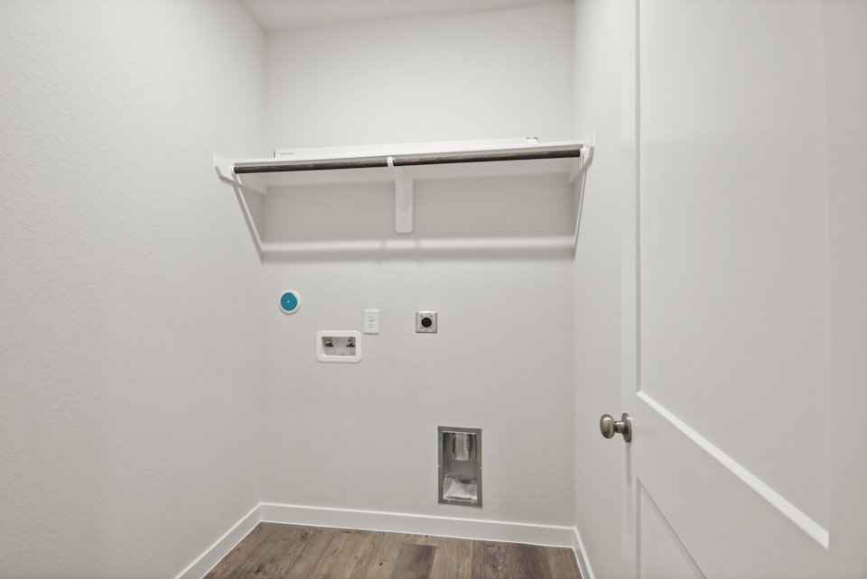 A white wall with a light fixture.