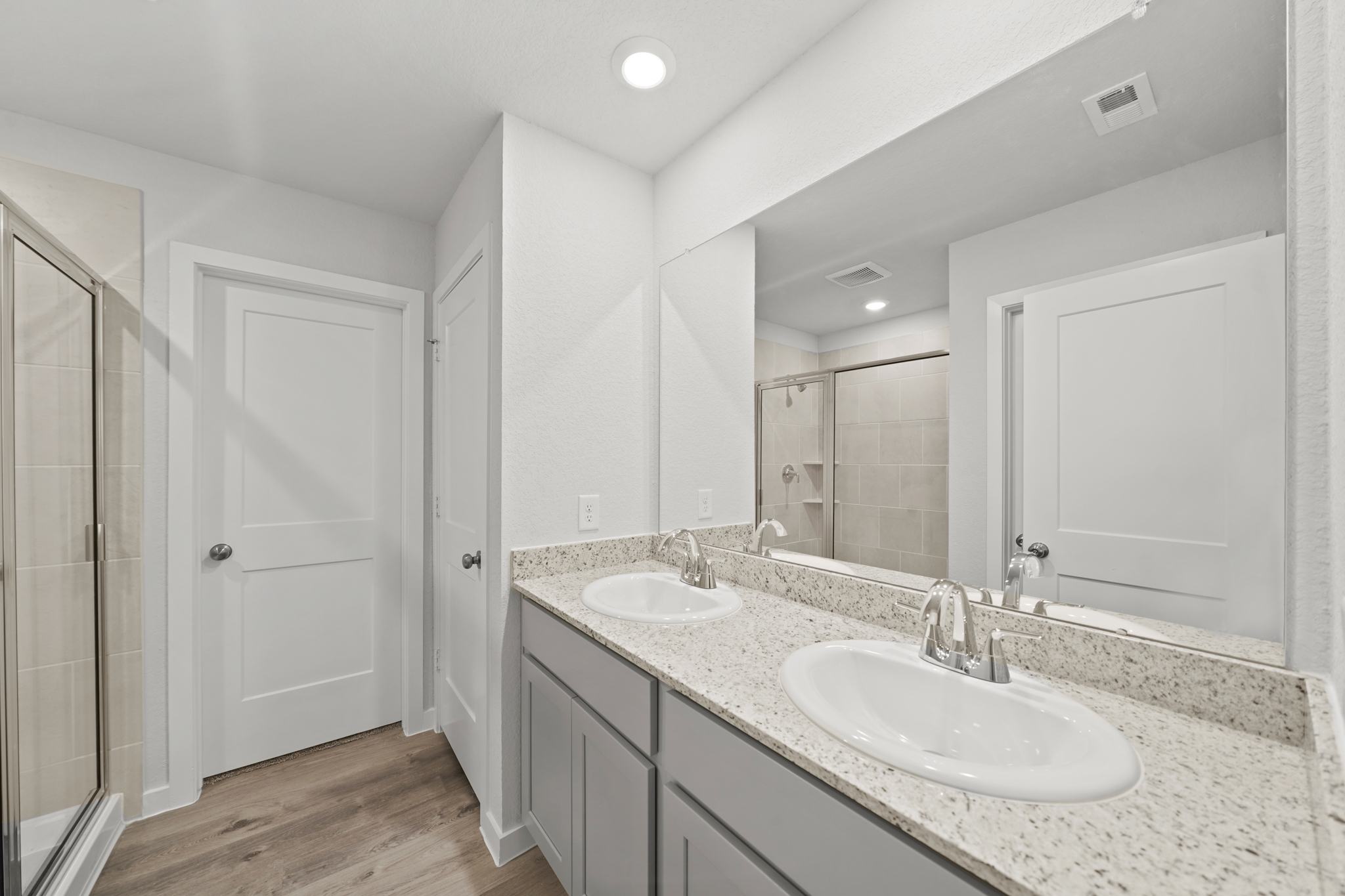 A bathroom with a large mirror.