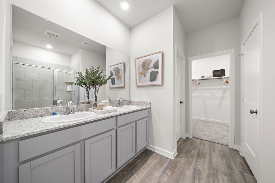 A bathroom with a large mirror.