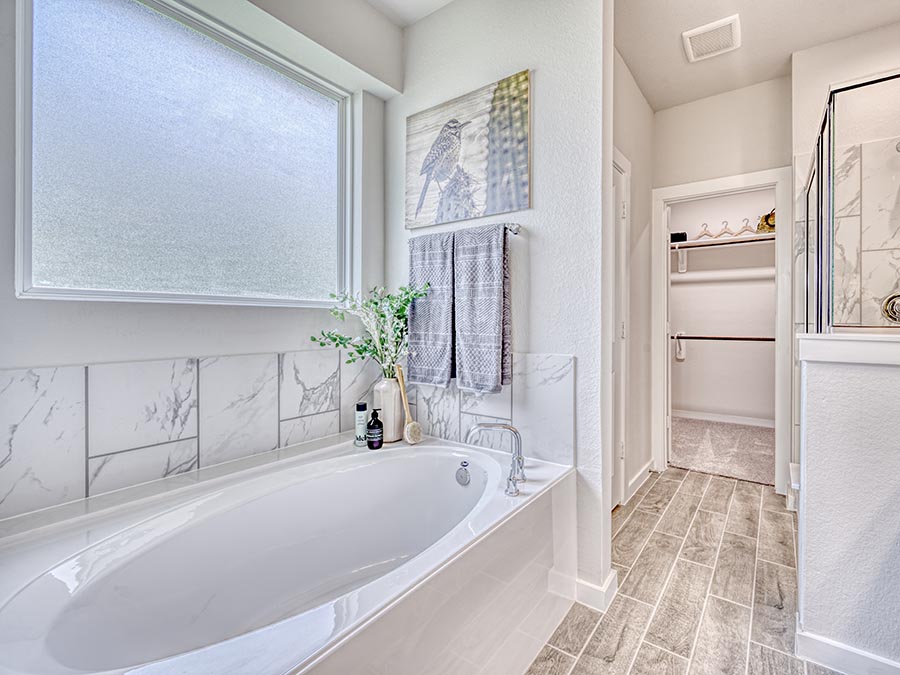 A bathroom with a tub and sink.