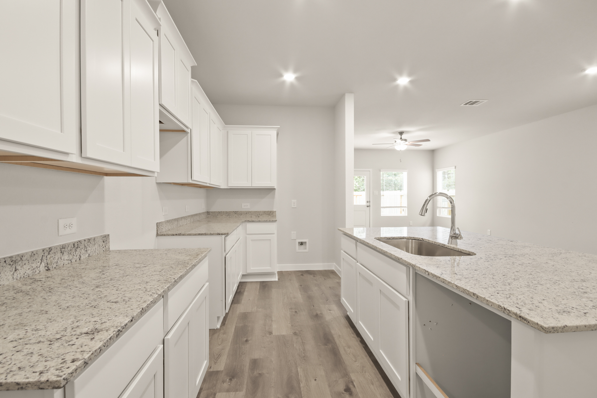 A kitchen with white cabinets.