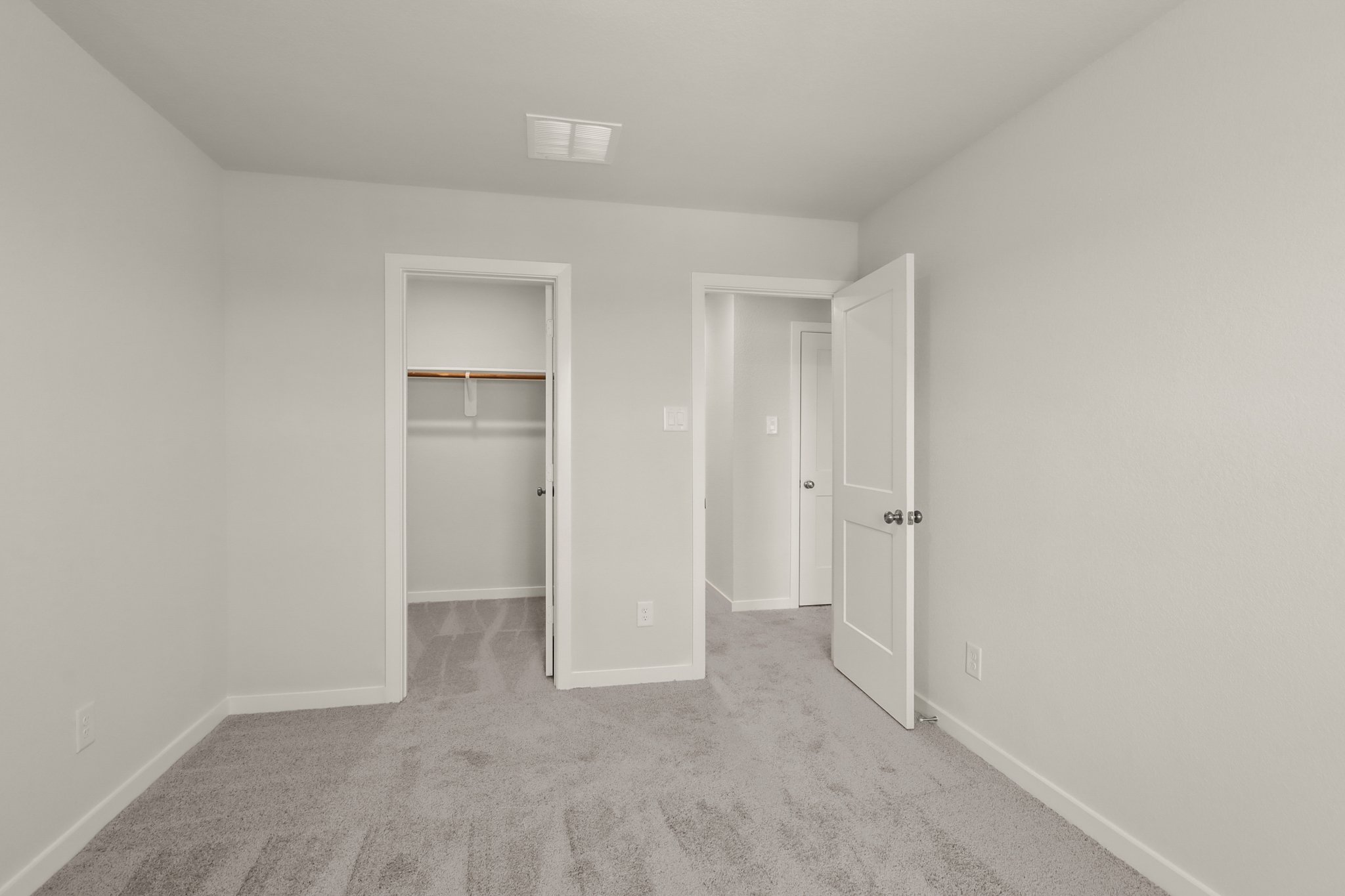 A hallway with white doors.