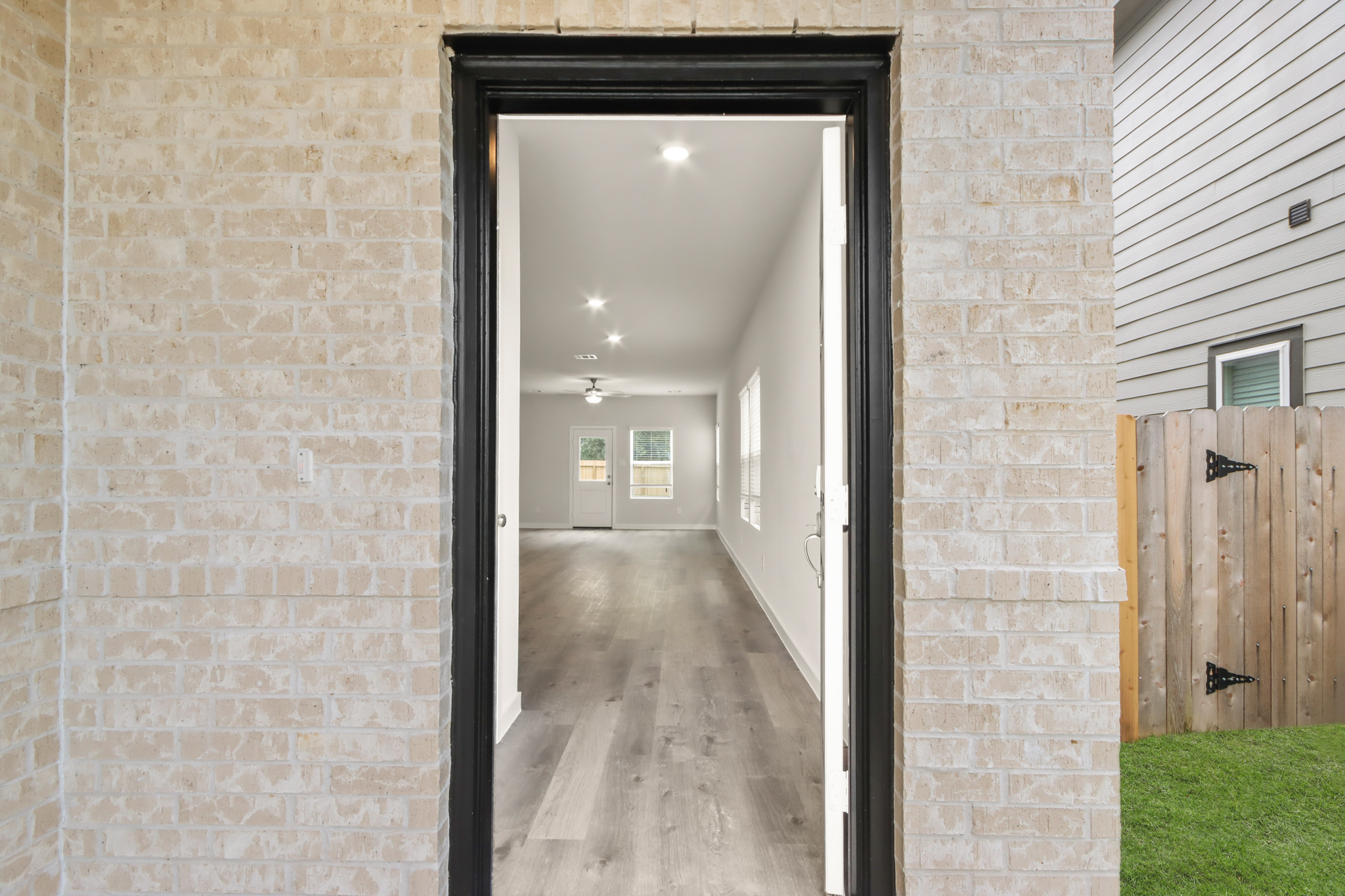 A hallway with a door open.