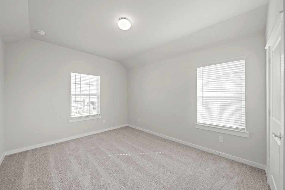 A room with a window and a carpet.