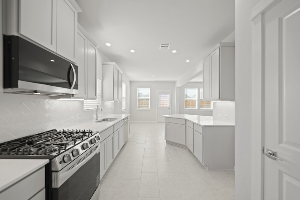 A kitchen with white cabinets.