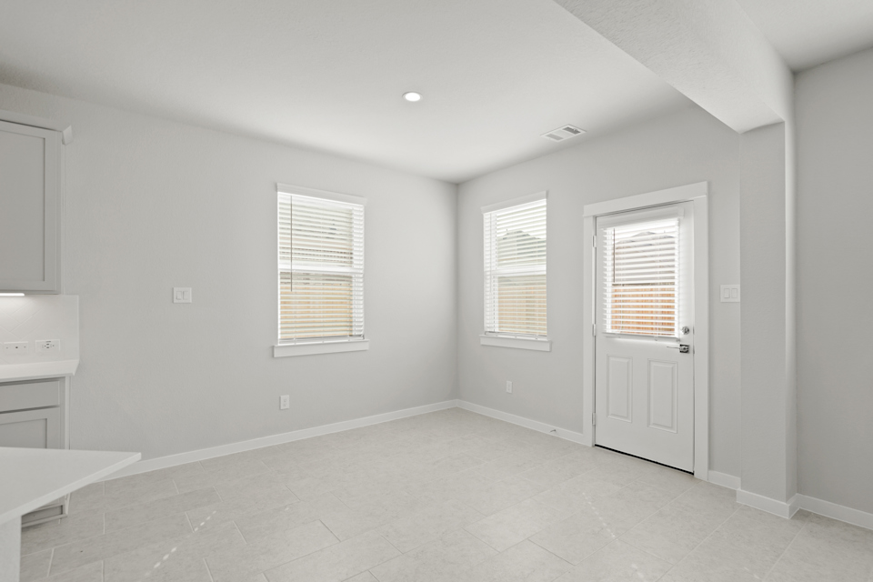 A room with white walls and a white door.