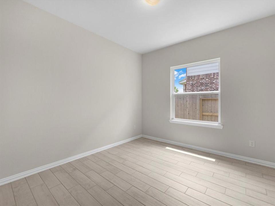 A room with a window and a tile floor.
