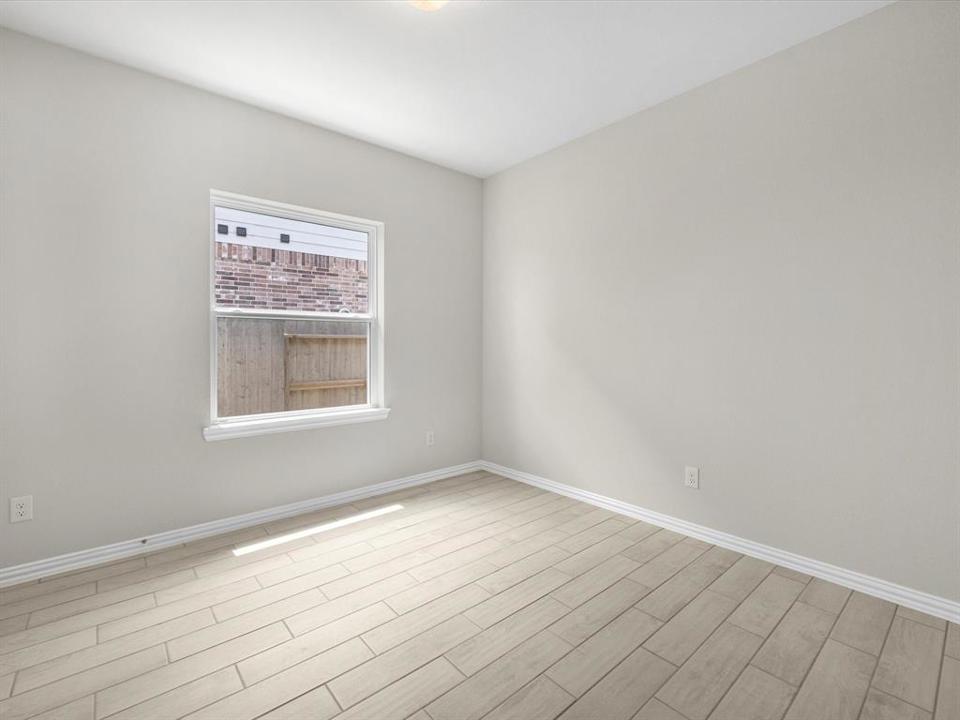 A room with a tile floor and a window.