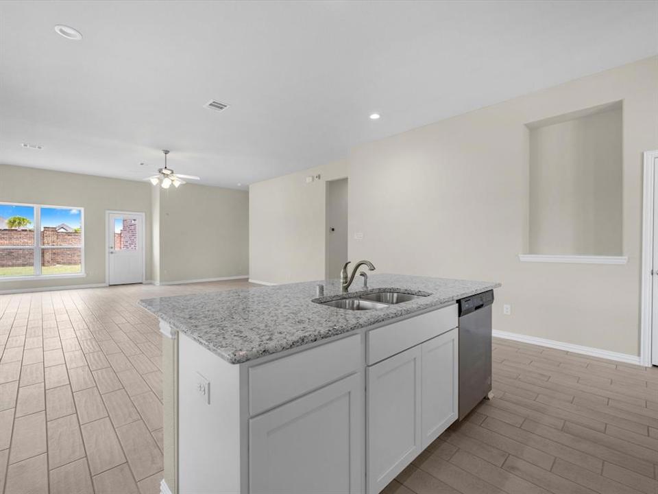 A kitchen with white cabinets.