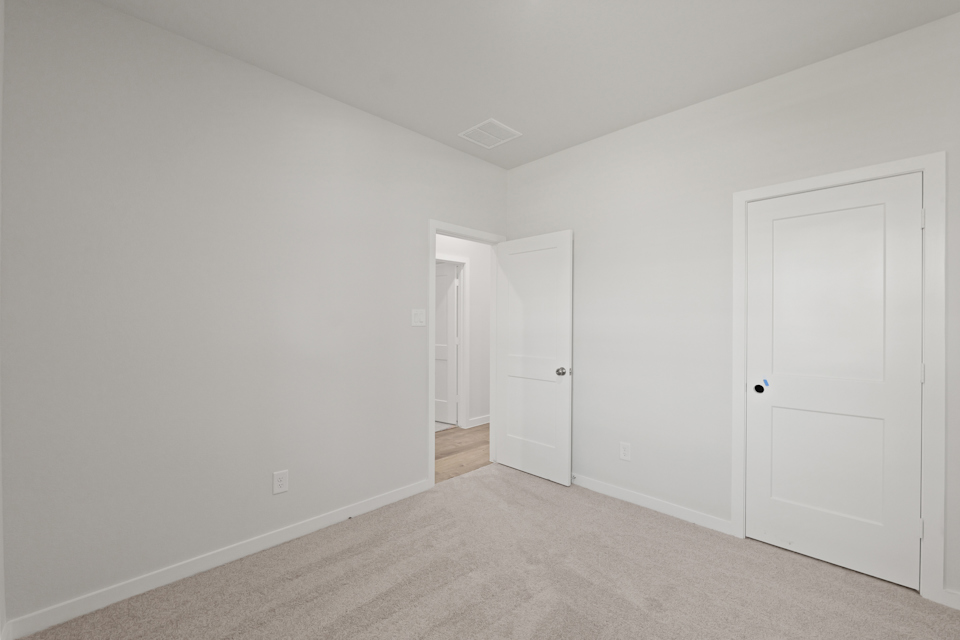A hallway with white doors.