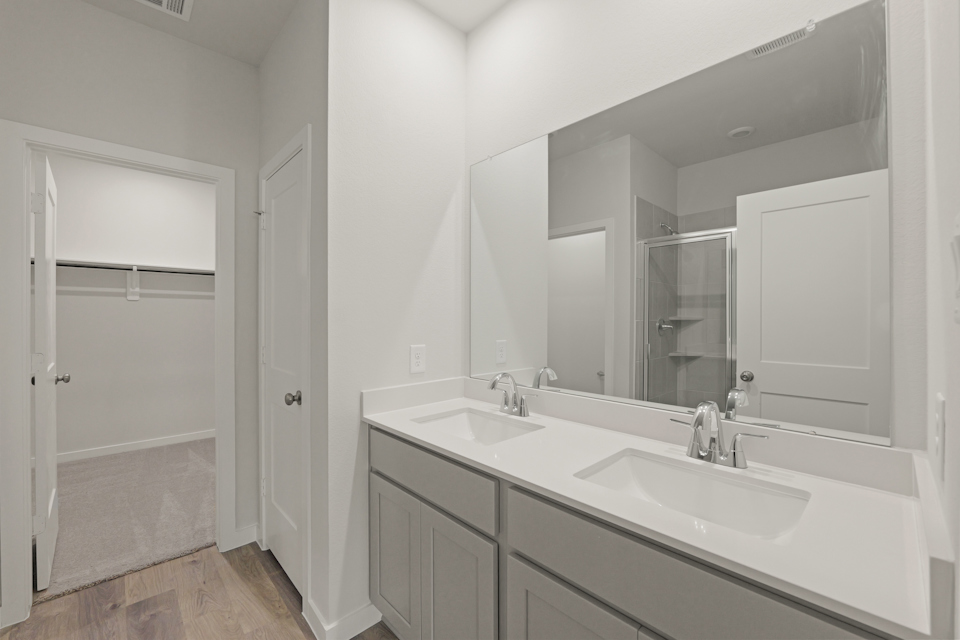 A bathroom with a large mirror.