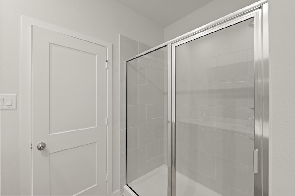 A shower with a glass door.