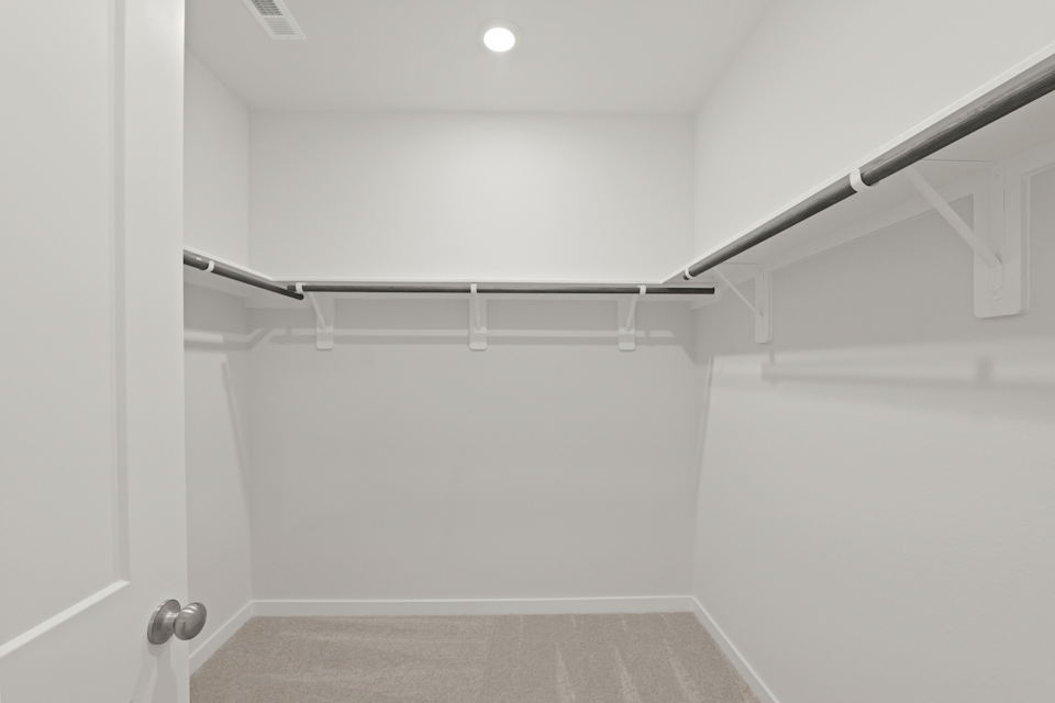 A white room with a metal railing.
