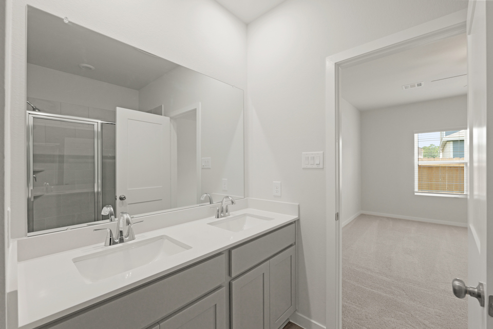 A bathroom with a large mirror.