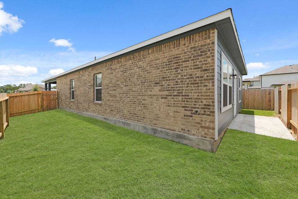 A brick house with a fence.