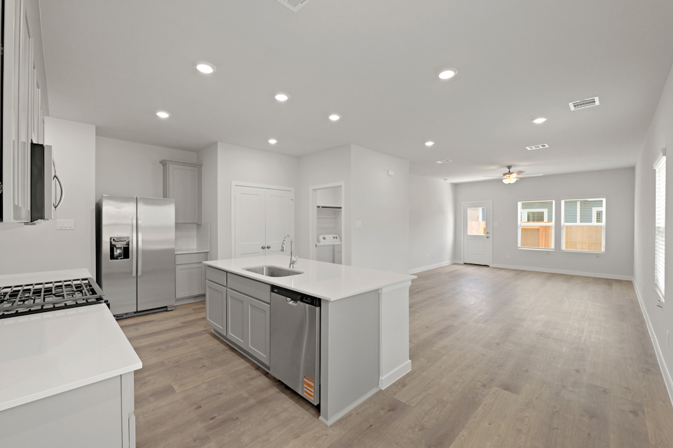 A kitchen with white cabinets.