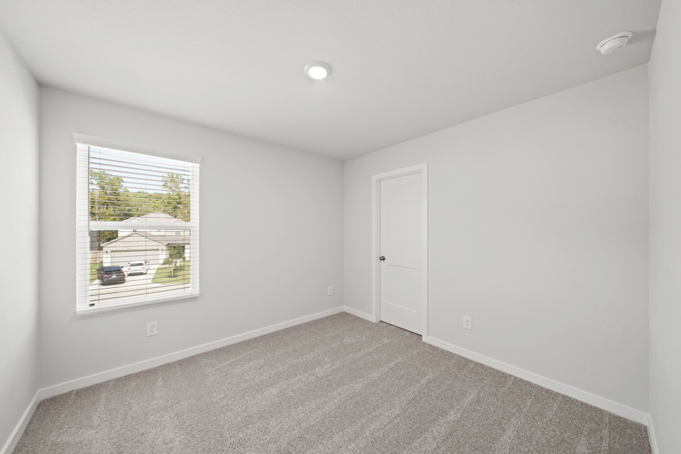 A room with a window and a door.