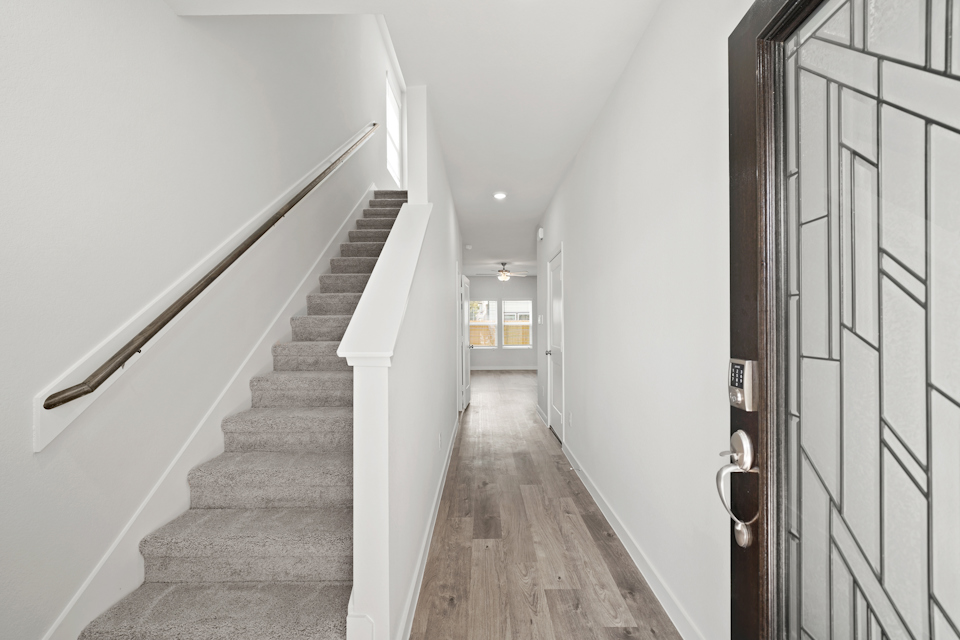 A long hallway with white walls.