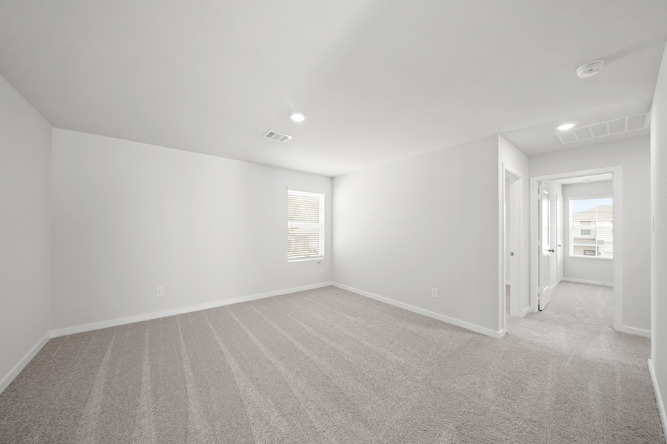 A room with a carpet and a door.