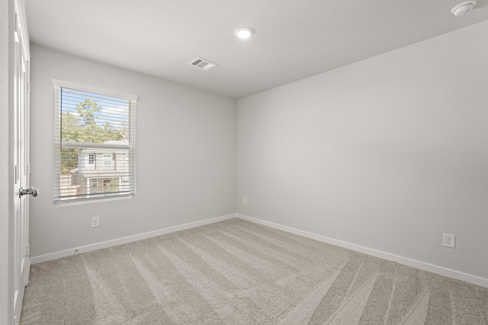A room with a window and a door.