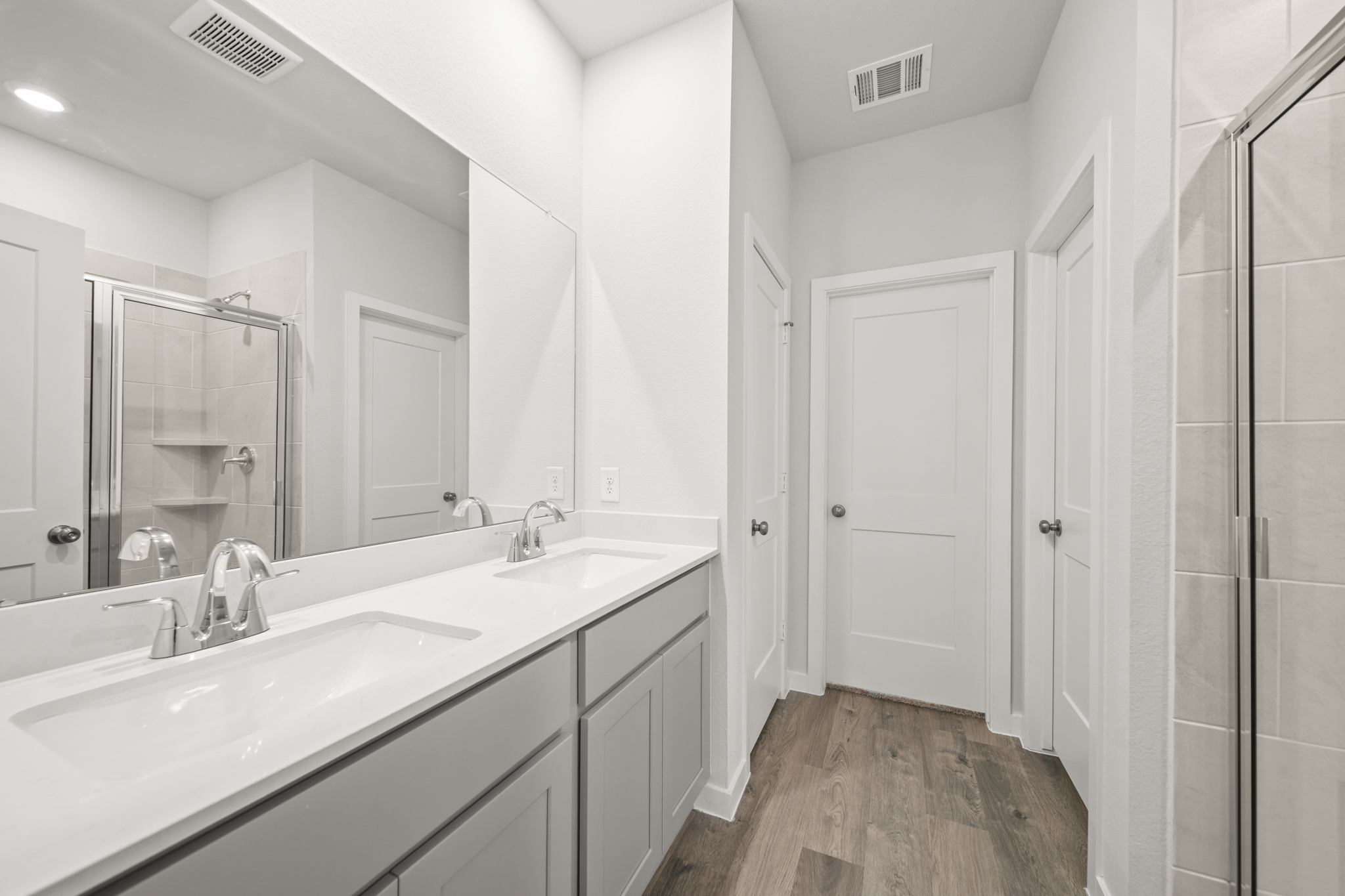 A bathroom with a large mirror.