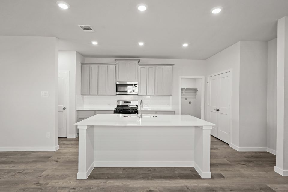 A kitchen with white cabinets.
