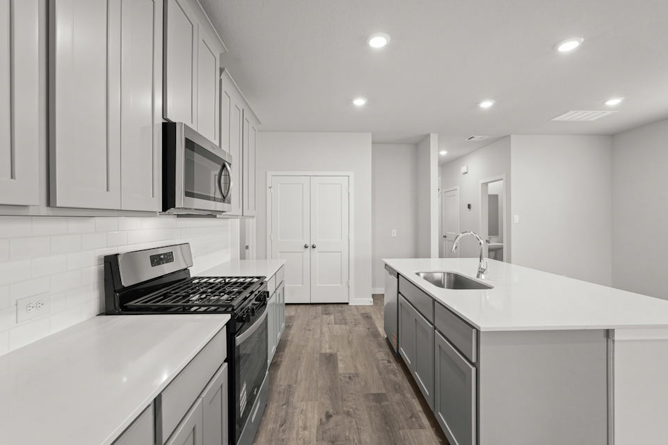 A kitchen with white cabinets.