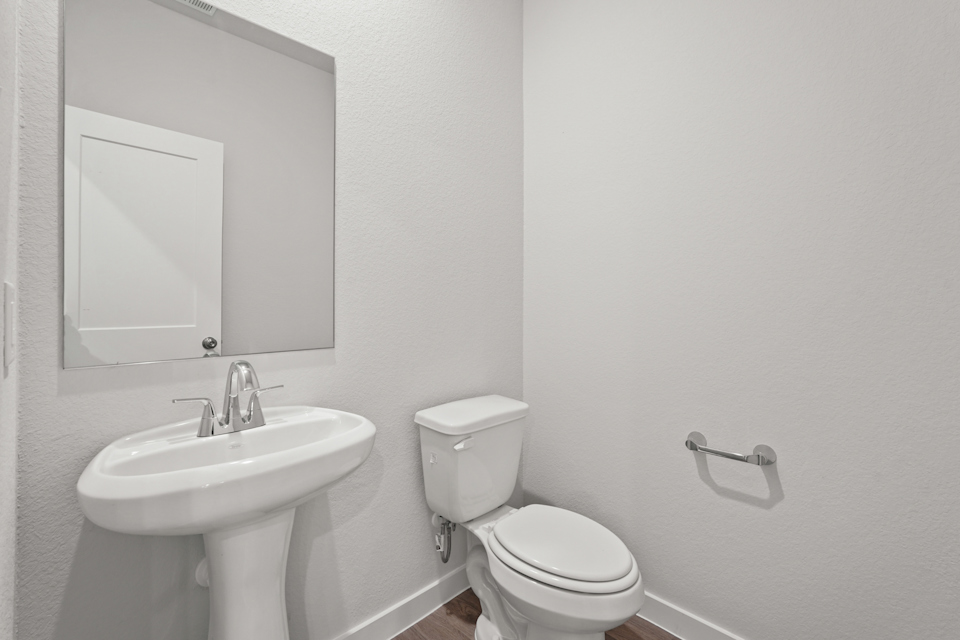 A bathroom with a toilet and sink.