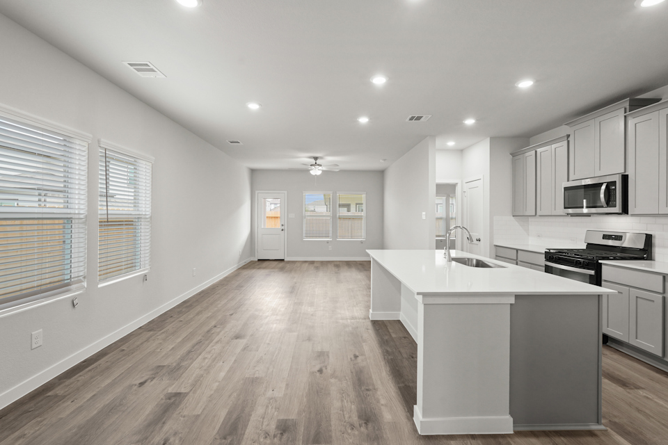 A kitchen with white cabinets.
