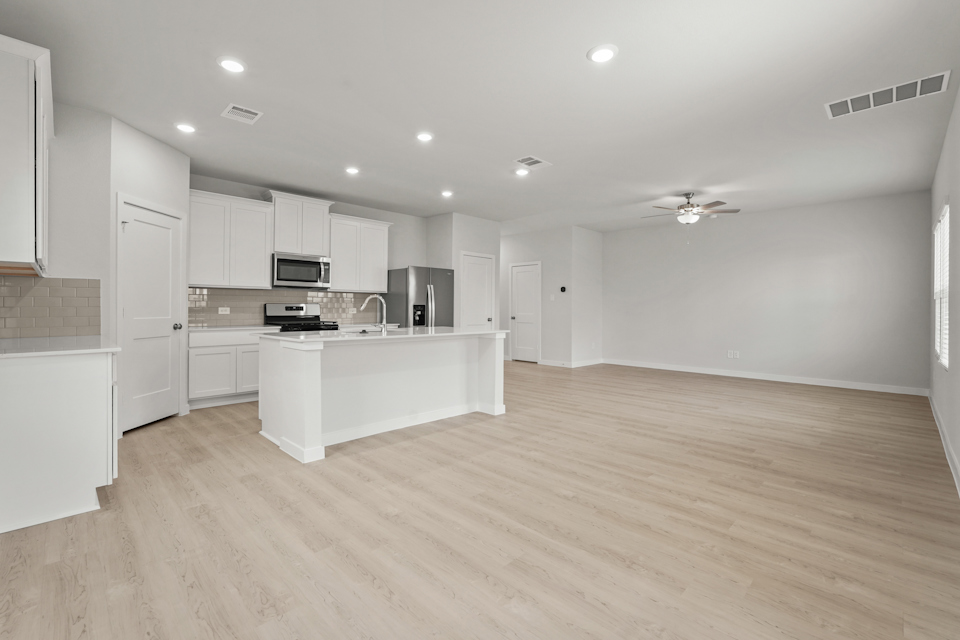 A kitchen with white cabinets.