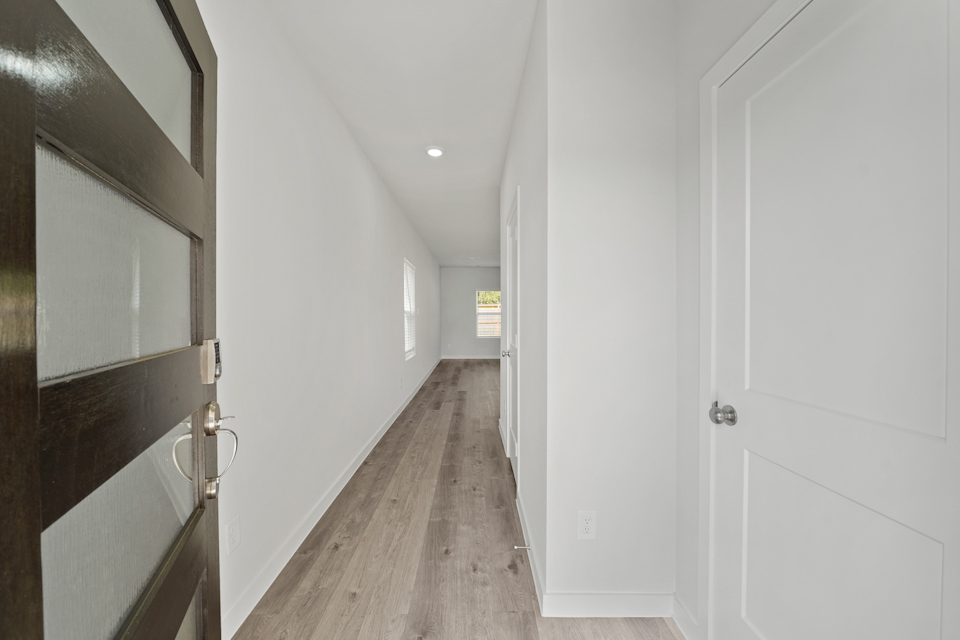A hallway with white doors.