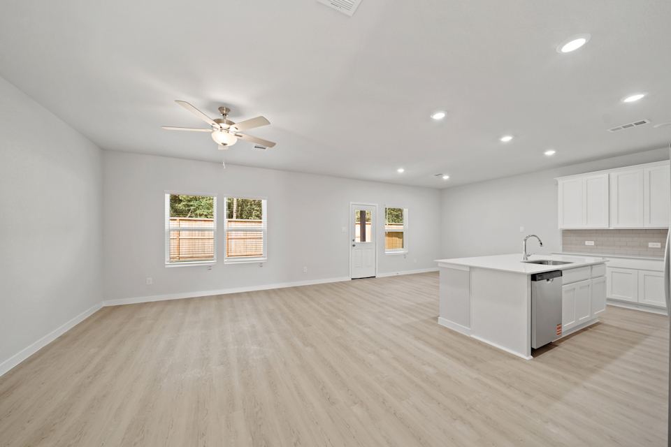 A kitchen with white cabinets.