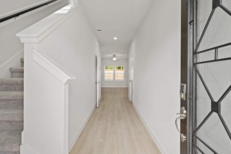 A hallway with white walls.