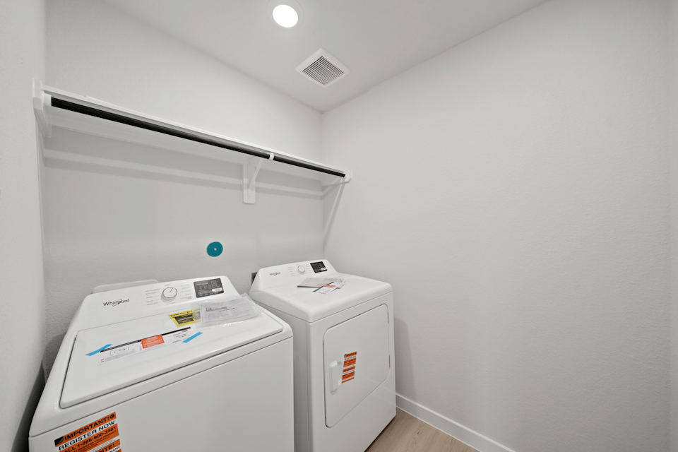 A washing machine in a room.