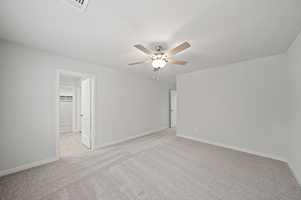 A room with a ceiling fan and a ceiling fan.