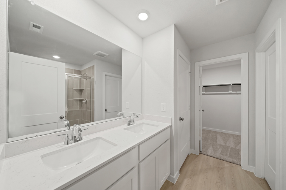 A bathroom with a sink and a shower.