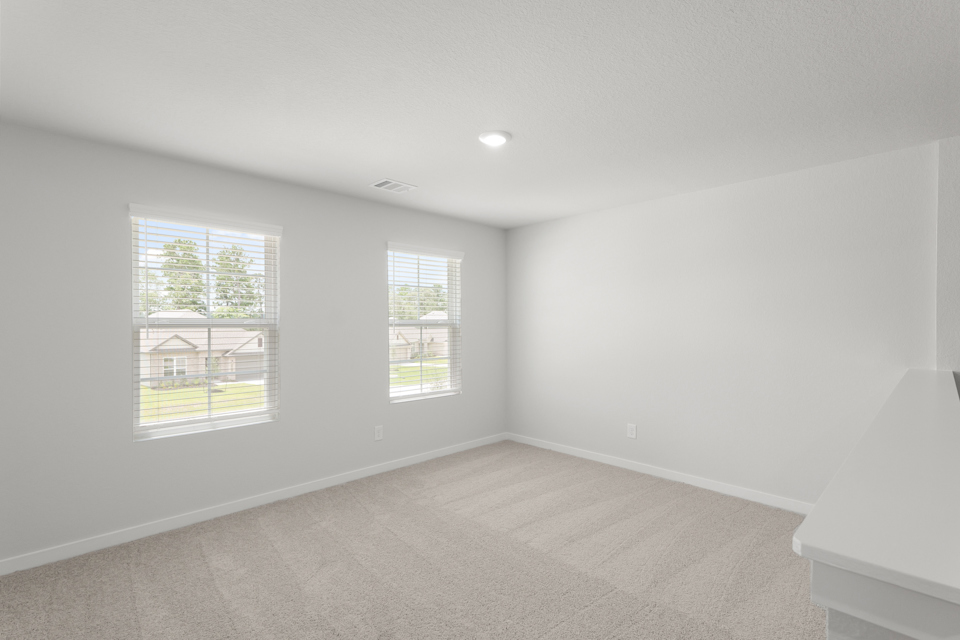 A room with a window and a couch.