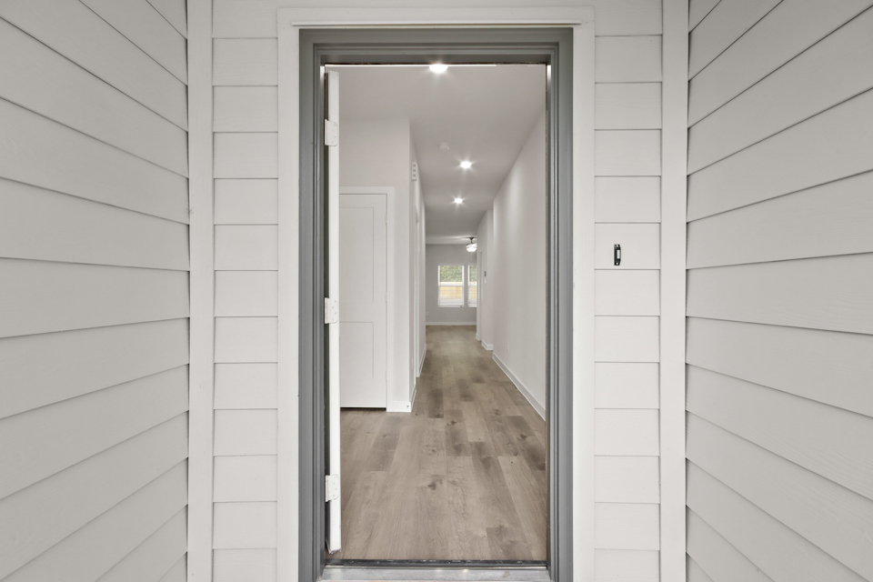 A hallway with white walls.